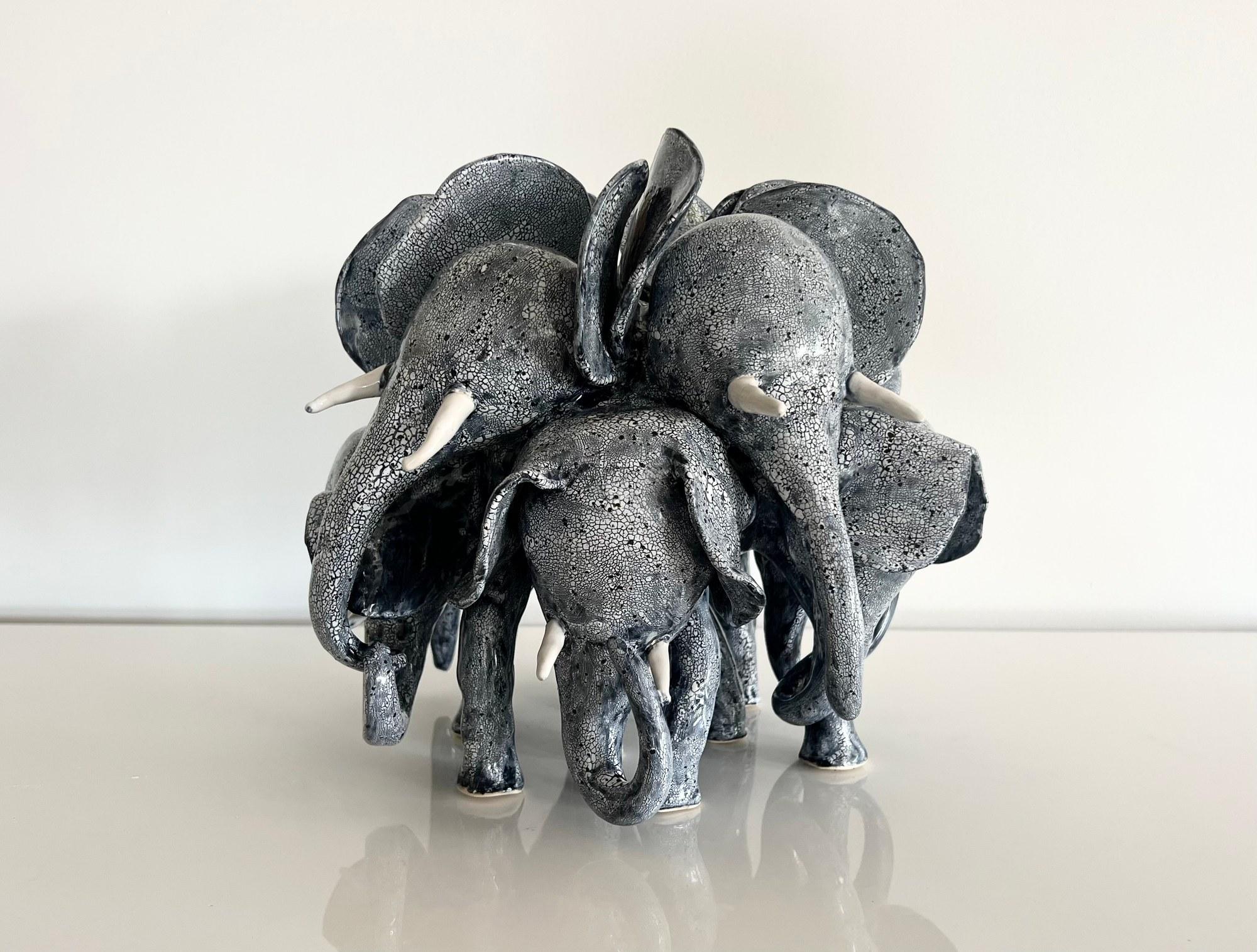 Crackled black and white elephant herd, front view