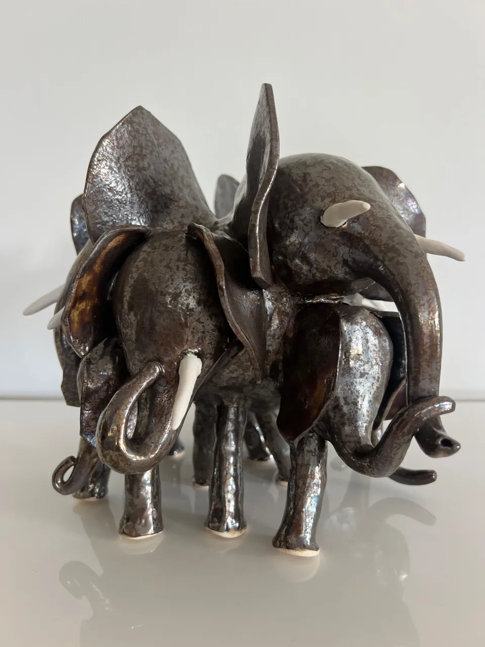 a lively gold elephant out for a herd walk
