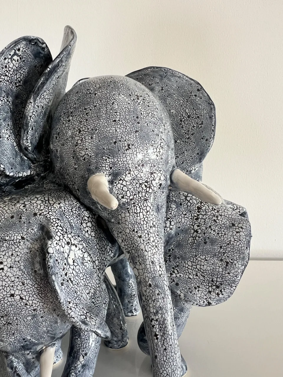A blue sparkling elephant in front of a white background