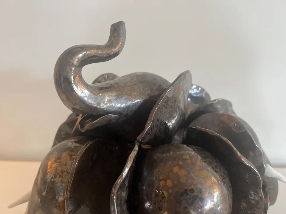 Zamari trumpeting its way around the herd who all have their heads down