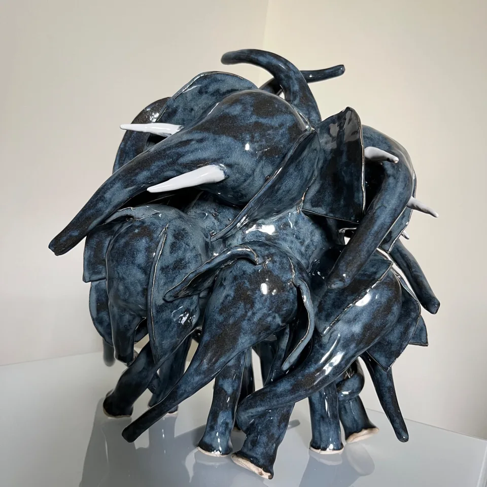 Dancing herd of blue elephants in a light setting