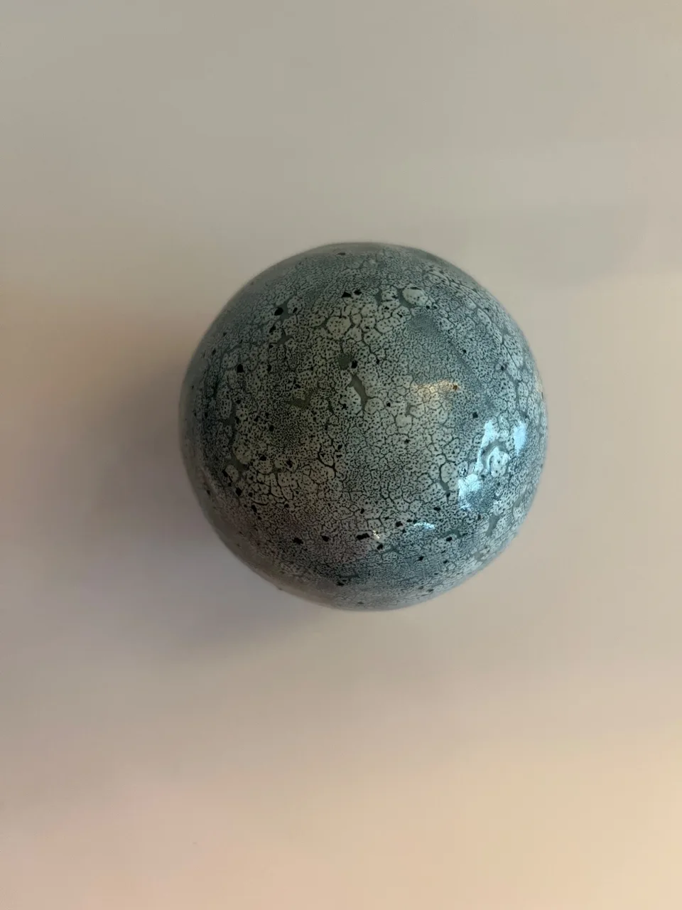 Glaze sample of crackling light teal in a small ball design