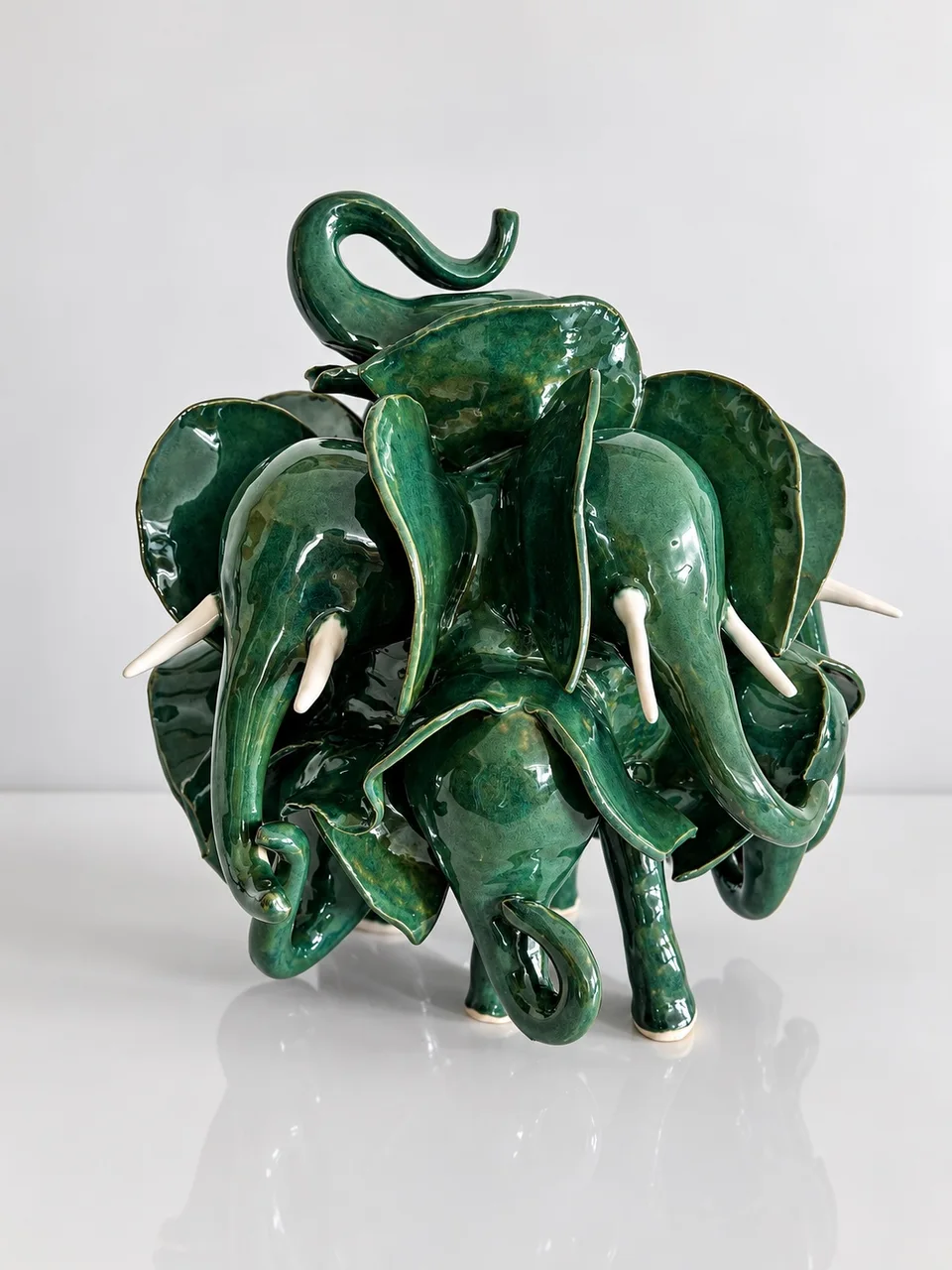 A beautiful green herd of elephants on a light background